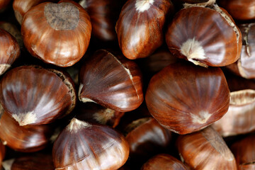 Delicious roasted edible chestnuts background. 