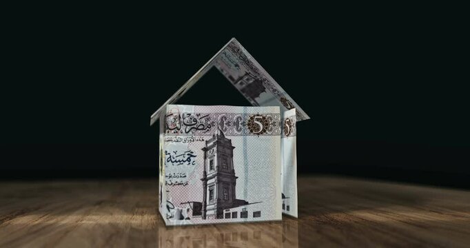 Libya dinar 5 LYD money banknotes paper house on the table. Libyan currency notes 3D concept of home mortgage loan, debt, rent, costs, liabilities and building wealth financing.