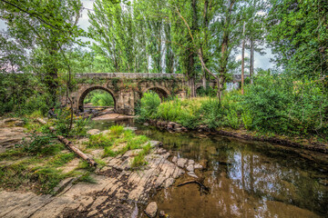 Serene Tera River Under Ancient Bridge in Almarza, Spain