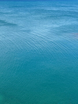 Blue sea water calm ripples surface background.