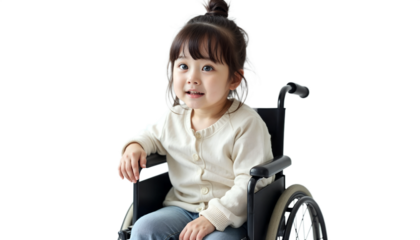 Smiling young girl sitting in a wheelchair on a black background, cheerful portrait.