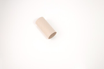 a single piece of brown toilet paper roll on a plain white background. how everyday objects can be transformed into part of project reusing or repurposing common household items,