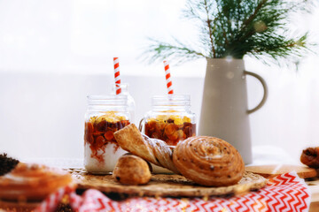 Christmas mood. Buns, milk, muesli, cookies at the New Year's breakfast. Table setting for children for the New Year