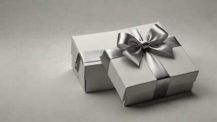 White gift box with silver ribbon on a white background.