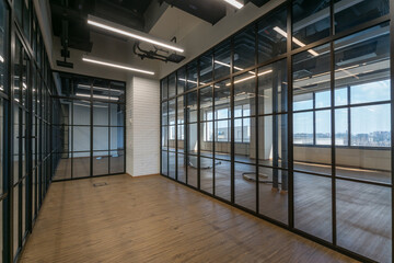 Modern office design in loft style. Glass partitions, panoramic windows.