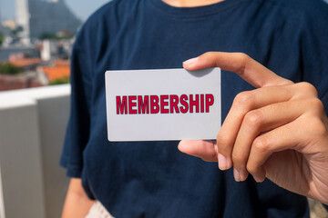 close up of woman's hand holding membership card