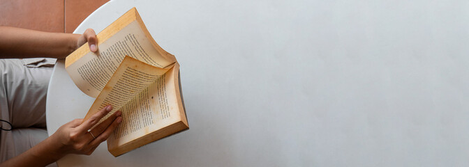 close up of a woman's hand reading a book