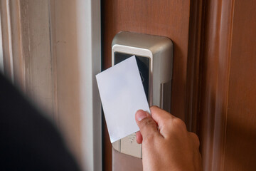 open smart door using card. female hand open the door.
