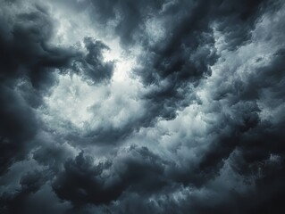 Obraz premium Captivating Dramatic Stormy Sky with Dark Gray Fluffy Clouds, Perfect for Atmospheric and Weather-Themed Photography, Highlighting the Beauty and Power of Nature's Tempest