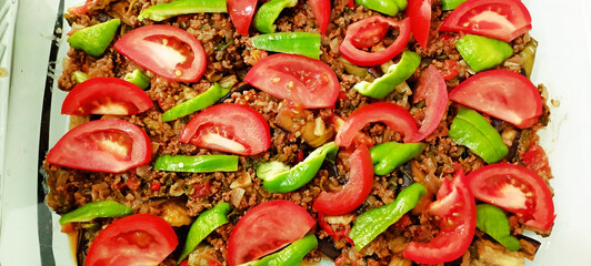 Lamb neck kebab with onions and vegetables on a tray in the hotel restaurant.