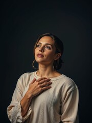 brunette woman with ponytail and hoop earings isolated on black
