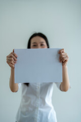 Businesswoman holding blank sign board for text placement