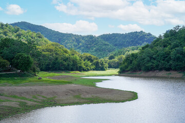 Lake landscape and mountain view and clouds with sunlight on blue sky at Huai Pradu Forest Ranger Unit, Lopburi, Thailand.