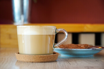 cappuccino mug in a cafe and cake