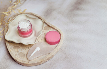 Anti-Age Face Cream and Gua Sha Stone in a Marble Tray