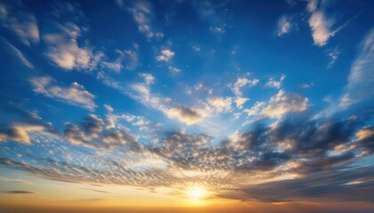 Fototapeta premium A breathtaking sunset with vibrant colors paints the sky as the sun dips below the horizon. The clouds are a mix of fiery orange and soft pink, creating a captivating scene.