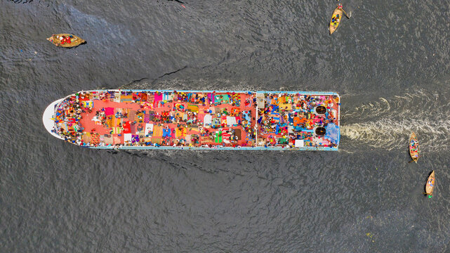 Aerial view of people taking passenger boats along the Burigaga river in Dhaka port, Keraniganj, Bangladesh.