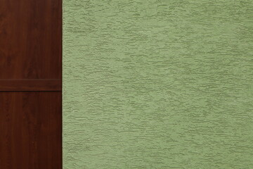 Wall with Wood Paneling and Textured Green Surface