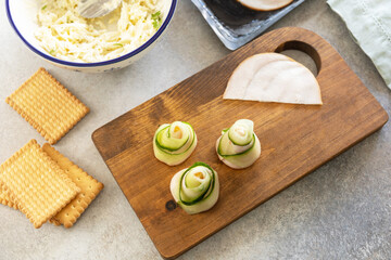 Cooking Christmas trees of ham, cucumber, cheese and star of carrot on crackers, step by step, step 3.