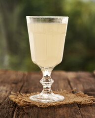 Fresh whey in a glass cup outdoors