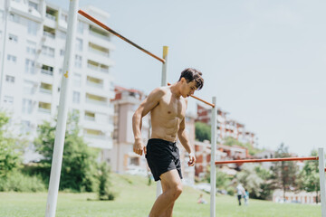 Fit and strong male athlete exercising outdoors in a park. Demonstrating fitness, health, and...