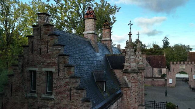 Exploring the historic architecture of Brugge's charming buildings and rooftops in daylight