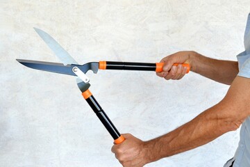 Large garden shears in hands of a worker.