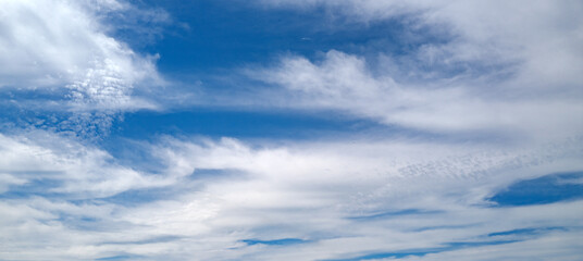 Fototapeta premium Blue Heaven and white clouds. Sky clouds background. White cloudy on Heaven with soft sun light. Clouds on pastel blue sky background. Sky Landscape Background. Sky Clouds Wallpaper.