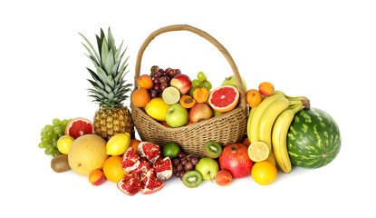 Many different fresh fruits in wicker basket isolated on white