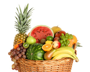 Many different fresh fruits in wicker basket isolated on white