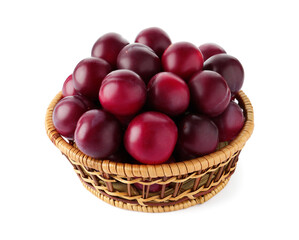 Fresh ripe plums in wicker bowl isolated on white