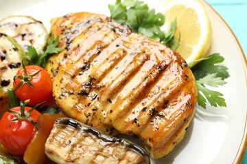 Delicious grilled vegetables and chicken breast on plate, closeup