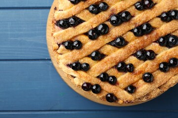 Delicious homemade blueberry pie on blue wooden table, top view