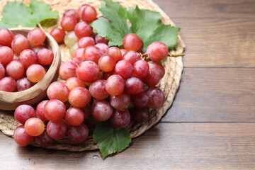 Delicious fresh ripe grapes on wooden table