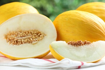 Fresh ripe melons on white table outdoors, closeup