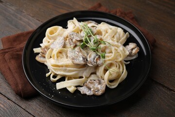 Delicious pasta with mushrooms on wooden table, closeup