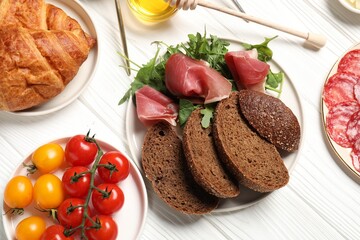 Different tasty food served for brunch on white wooden table, flat lay