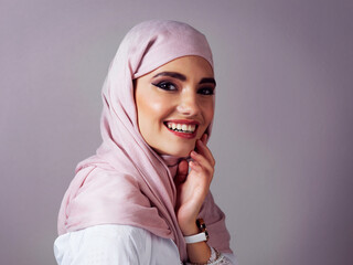 Smile, portrait and makeup with muslim woman in studio for islamic style, arabic culture and raya clothes. Fashion, eid Mubarak celebration and hijab with person on background for oriental design