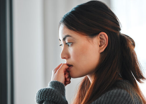 Mental health, woman and nervous of stress in home with failure, paranoid or regret trauma. Overthinking, person and anxiety in house for ptsd, isolation or victim phobia with thinking or nail biting
