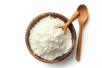 Top down view of tapioca starch enclosed in a wood bowl and spoon separate from the background on white surface