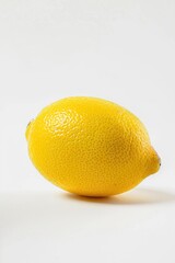 A single lemon sitting on a white table