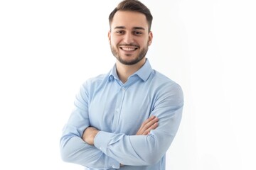 A person standing with their arms crossed, wearing a blue shirt