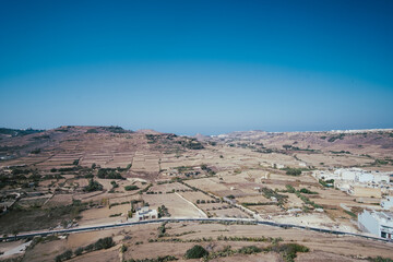 Barren brown fields in a beautiful skyline of the Gozo island, Malta