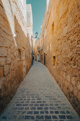 Fototapeta premium Beautiful old tight streets with cobble stones in the old town of Gozo, Malta