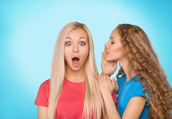 Handsome young friends sharing secret or gossip