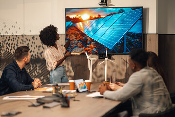 Diverse casual businesswoman presenting solar panels solution at office