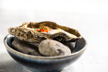 Golden oyster with red caviar and herb