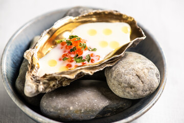 Golden oyster with red caviar and herb