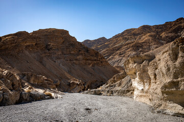 A view of the entrance to the Mosaic Canyon in Death Valley, California, showcasing its intricate geological formations shaped by centuries of erosion.