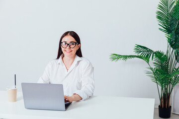 Business woman brunette smiling at work in office with laptop